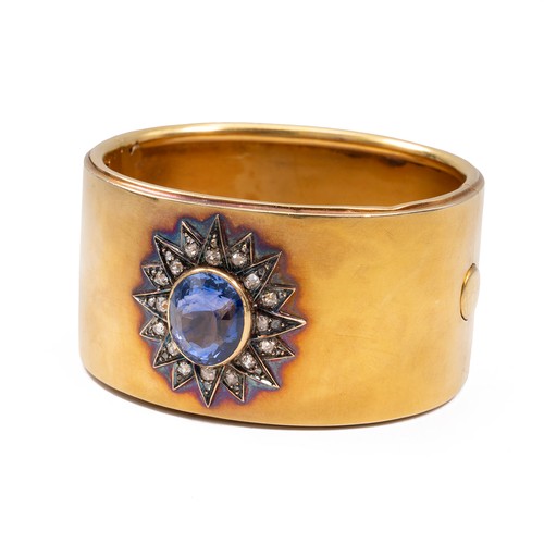 121 - A late 19th-century gold, diamond and sapphire cuff bangle, the oval sapphire measuring approximatel... 