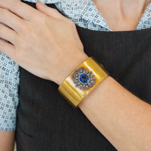 121 - A late 19th-century gold, diamond and sapphire cuff bangle, the oval sapphire measuring approximatel... 