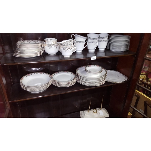 93 - Two shelves of various part Tea sets inc Noritake etc., also to include a Belleek Desk Stand.