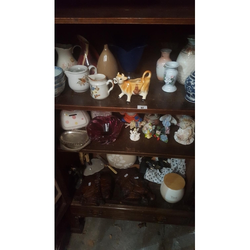 92 - CHARITY: A large quantity of items on 3 shelves along with a Magazine rack, Planter, a coffee Table,... 