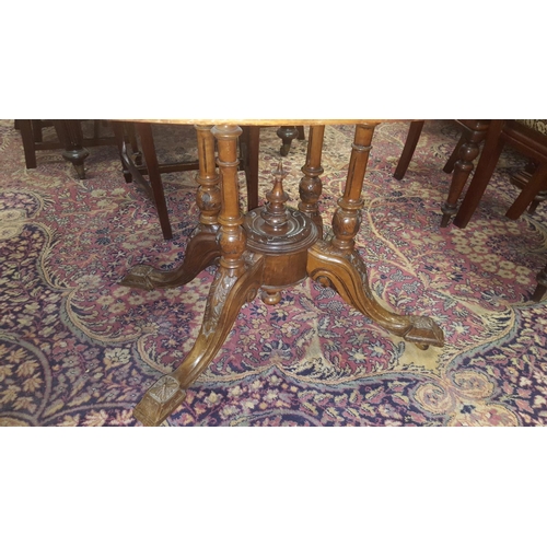 46 - A Victorian Walnut Loo Table with inlaid top on a four legged pod.