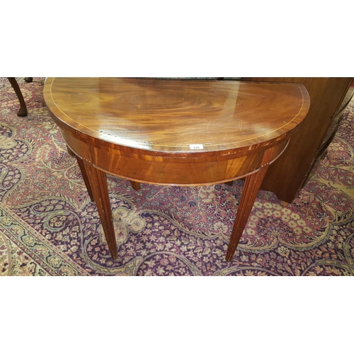 646 - A Regency Mahogany fold over Card Table on reeded and fluted tapered supports.