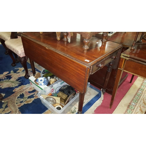 52 - A Georgian Mahogany Pembroke Table on turned supports.