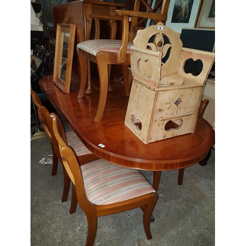 57 - A Yew wood Dining Table along with a set of chairs.