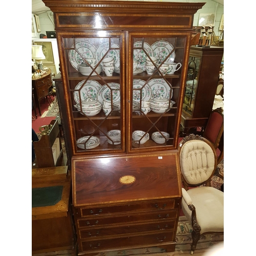 1006 - A good Regency style Mahogany inlaid Bureau Bookcase with astragal glazed upper section and fully fi... 