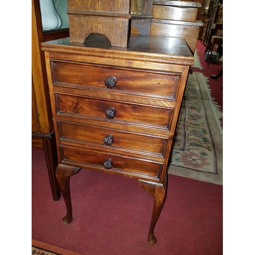 1011 - A reproduction Mahogany Bedside Chest of four short drawers.