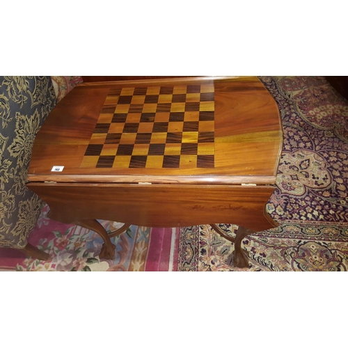 82 - A Modern Mahogany Drop Leaf Table with a Games top.