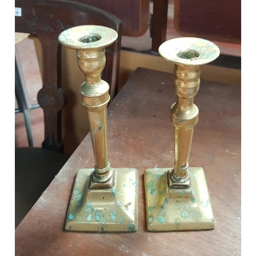 109 - A pair of Brass Vases and a pair of Brass Candlesticks.