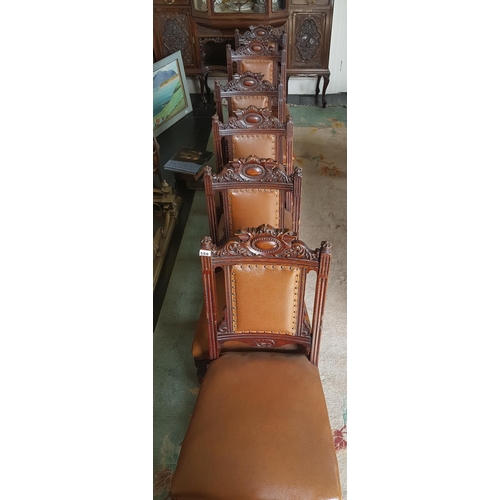 559 - A superb set of twelve upholstered Dining Chairs with highly carved backs.