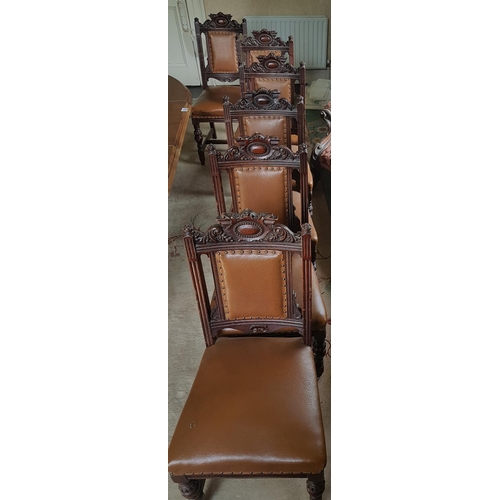 559 - A superb set of twelve upholstered Dining Chairs with highly carved backs.