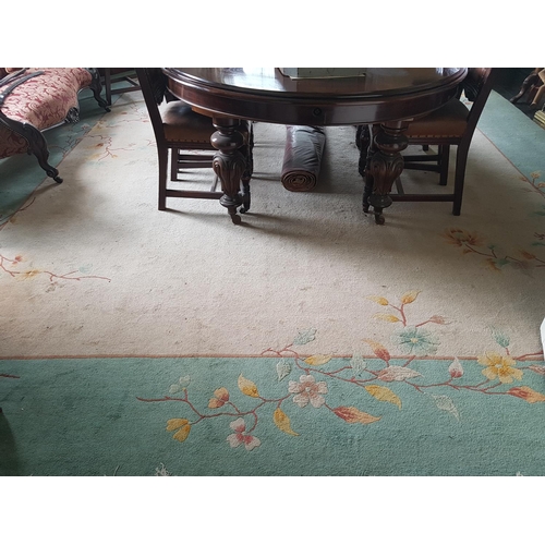 567a - A good large Oriental style Rug with leaf and floral decoration on a cream and green ground. 496 x 3... 