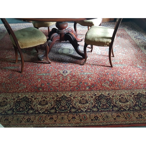 589 - A large Burgundy/Rust ground Rug with 'Tree of Life' decoration and multi borders. 363 x 275cm.