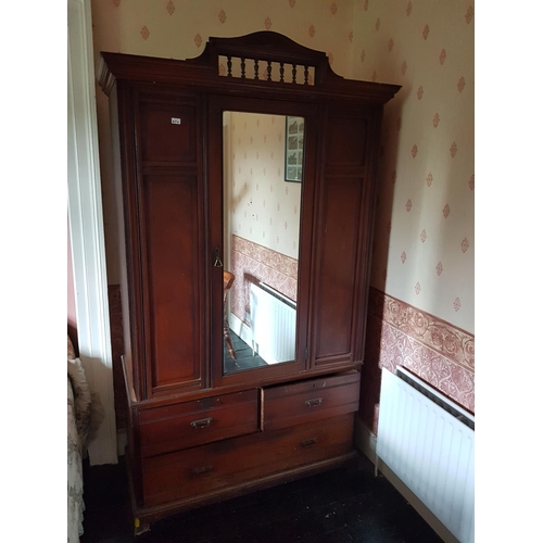 673 - An Edwardian Walnut Wardrobe.