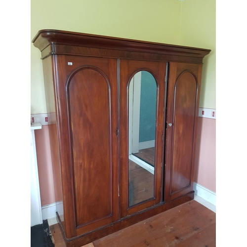 685 - A Victorian Mahogany three door Wardrobe with a mirrored centre door. H 205 x 200cm.