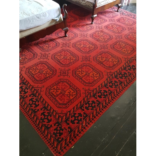 703a - A good Burgundy ground Rug with repeating decoration. 354 x 274cm.