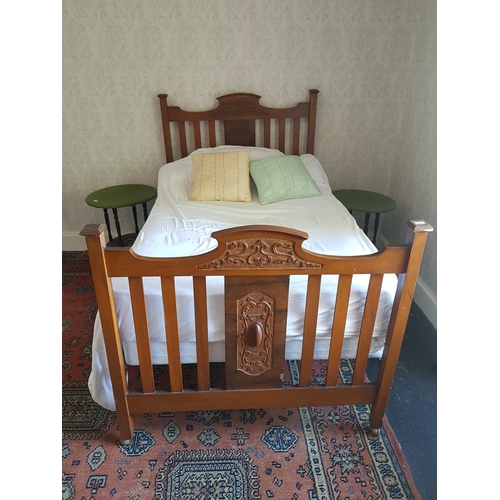 714 - An early 20th Century Walnut large single Bed with a carved head and footboard. W 122cm.