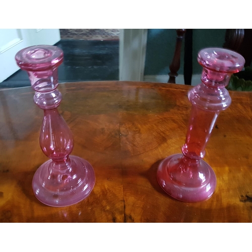 585 - A pair of Cranberry glass Candlesticks.