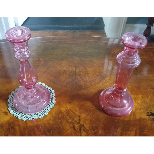 585 - A pair of Cranberry glass Candlesticks.