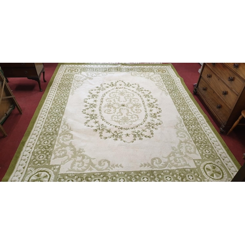 504 - A large Cream and Green ground Rug with multi borders. 358 x 270cm.