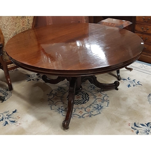 874 - A fabulous 19th Century Rosewood veneered circular Dining Table on a carved tripod base. Diam.137cm.