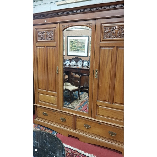 165 - A really good 19th Century Mahogany Three Door Wardrobe with ?? panel top.