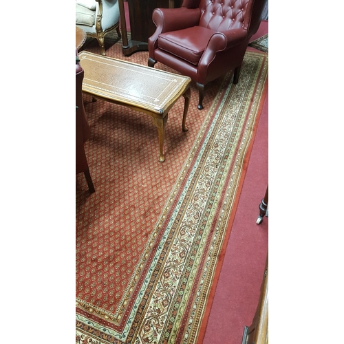 257 - A large Rust Ground Carpet with multi borders and repeating pattern centre.350 x 250 cms.