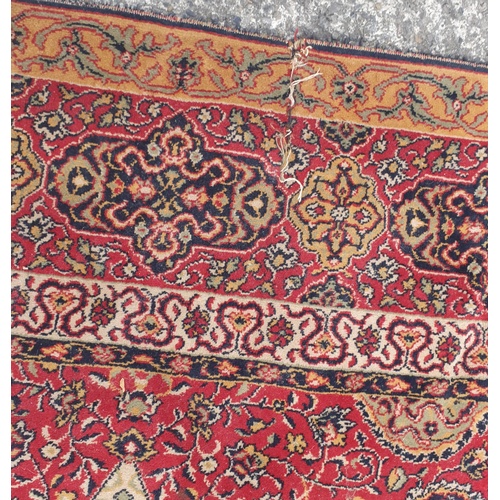 217 - A large red ground Carpet with multi borders. approx 370 x 270cms. Slight damage.