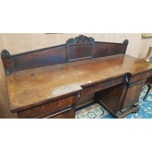 339 - An Irish William 1Vth Mahogany Pedestal Sideboard with a carved and moulded base and doors and with ... 