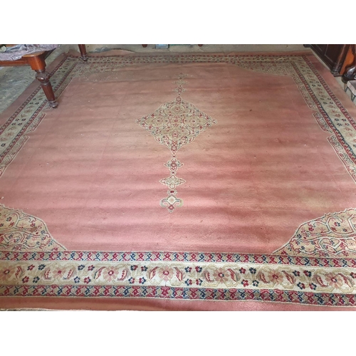 121 - A large Pink ground Carpet with multi borders and centre decoration. 415 x 406 cms.