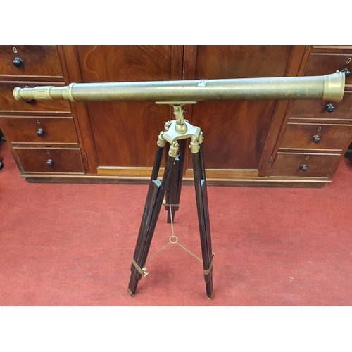 412 - A Brass Telescope on a timber stand.