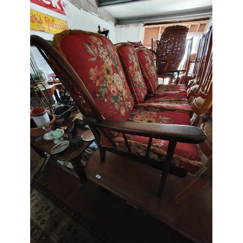 117 - An Ercol style Three Piece Suite consisting of a three seater couch an armchair and a rocking chair.