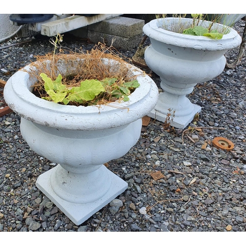 23 - A pair of reconstituted painted Stone Urns.