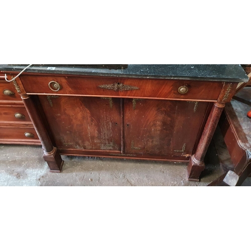 233 - An early 19th Century Mahogany Empire two door Cabinet with ormolu mounts and a black marble top. (d... 