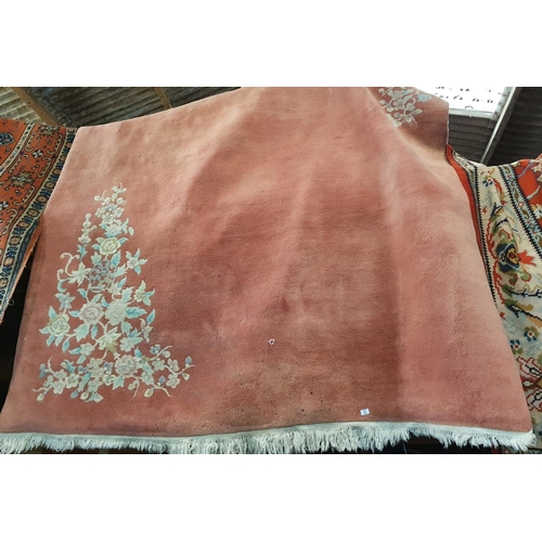 304 - A large Pink ground Rug. Approx 340 x 240 cms.