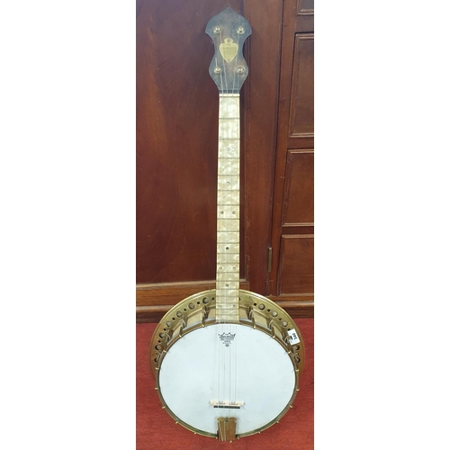 340 - A Brass four string Banjo 'The Broadcaster' by J & A M, London. Circa 1920's.