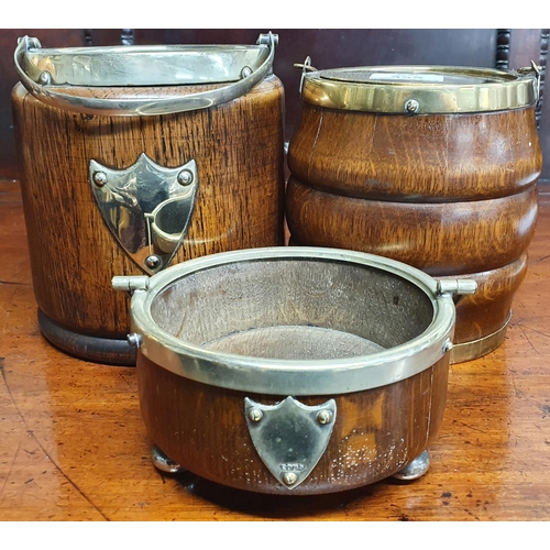 395 - Two Oak and Brass bound Biscuit Barrels along with an oak and metal bound coaster.