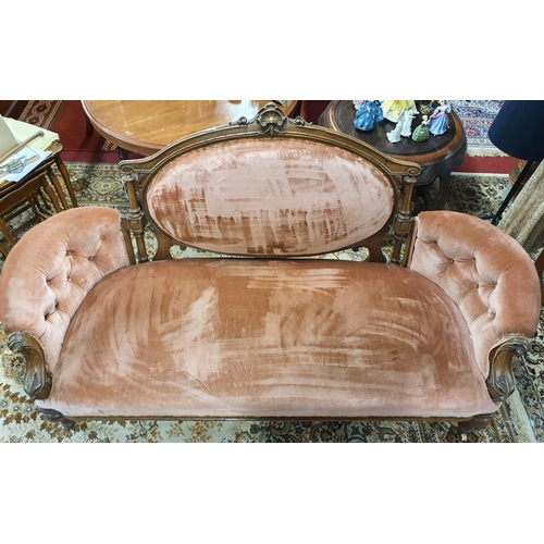 408 - A Victorian Walnut Showframe Couch with carved outline and turned supports.