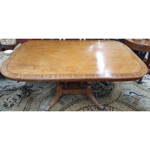 930 - A Fantastic large Regency Mahogany Breakfast Table, the rectangular crossbanded tilt top upon four t... 