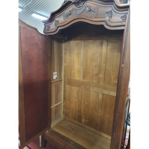 310 - A 19th Century Walnut Armoire with mirrored doors and hanging interior.120w x 45d x 245h cms.