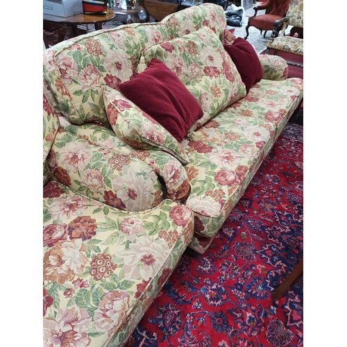 490 - A good three seater Couch, Armchair and Stool in a floral pattern. By Finline Furniture.