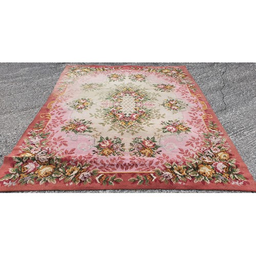 432 - A pair of Navan Carpets with pink ground and floral decoration. 360 x 275 cms each.