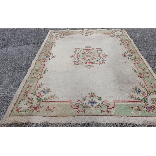 434 - A cream ground Carpet with green tones.  360 x 270 cms approx.