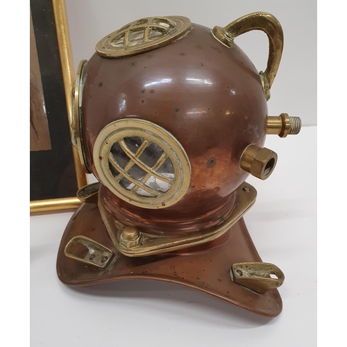 205 - A miniature example of a deep sea Diving Helmet in copper and brass along with a coloured Print and ... 