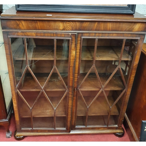 296 - A top quality Georgian Mahogany glazed bookcase with reeded glazed doors on bun feet.
W 104 X D 30 X... 