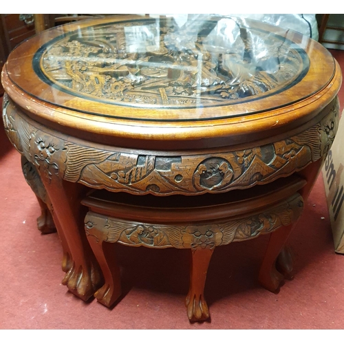 71 - A good Hardwood Oriental Nest of Tables where the triangular tables fit under the main table.D 76 cm... 