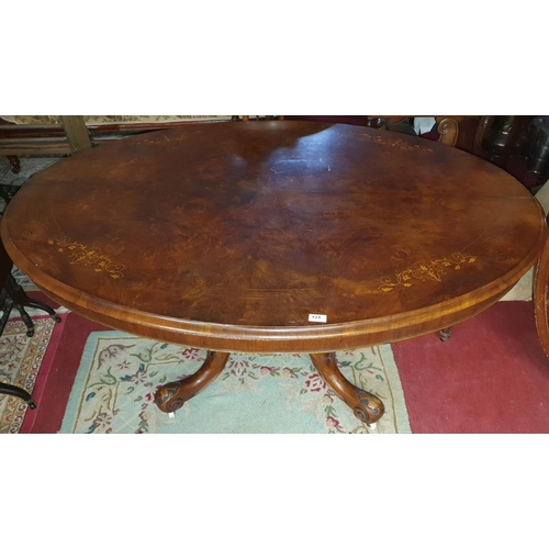 273 - A fantastic Victorian Walnut Inlaid oval Supper Table with splayed carved pod.c1860. 145 x 117 cms.