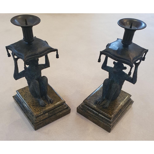 128 - A good pair of Bronze effect Candlesticks in the shape of a Monkey. On marble bases.