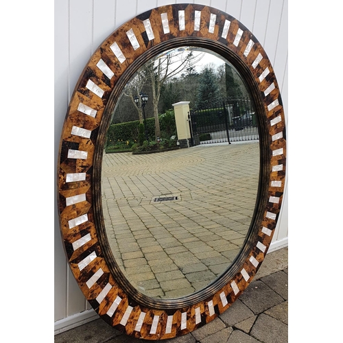 319 - A very large Tortoiseshell style and Mother of Pearl Oval Mirror. 118 x 138 cms approx.