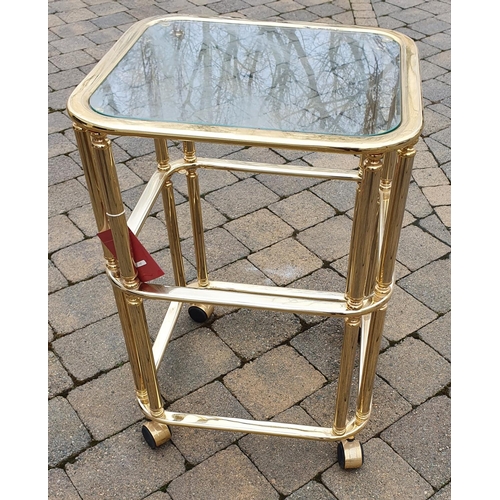 343 - A Brass and Glass three tier Dumbwaiter on castors.