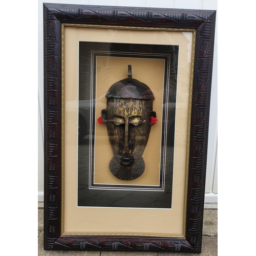 352 - An Unusual Brass and Copper African head in relief. Framed.